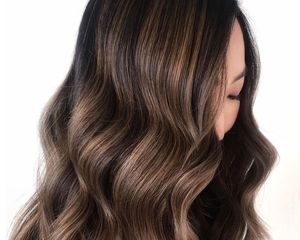 Side view of dark hairstyle with dimensional reverse balayage