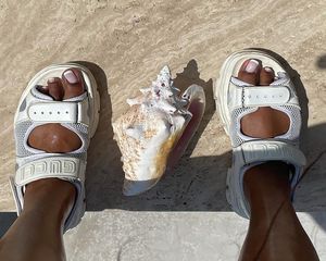 Lizzo with a French pedicure, wearing white Gucci sandals