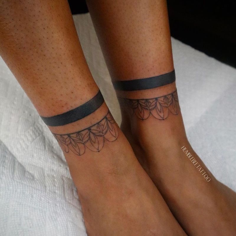 Matching ankle tattoos with solid and intricate bands