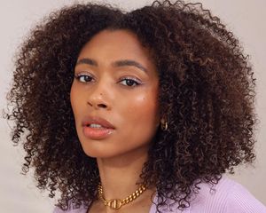 Woman with healthy natural curls and radiant skin