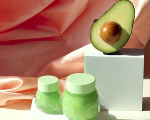 avocado and jars of lotion