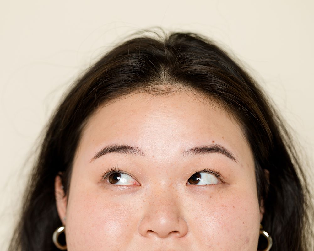 woman with brown hair looking up