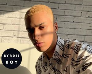 A young man with bleached hair with the sun on his face