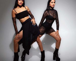 Meg and Komie Vora wearing black outfits and platform boots.