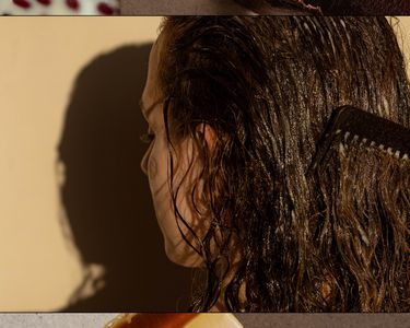 woman combing her brown hair