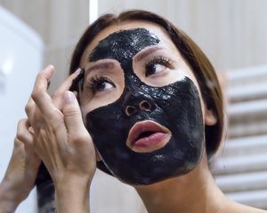 woman applying peel off mask