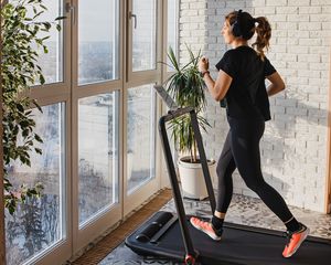 Woman running on a treadmill in her home