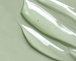 Strokes of gel texture on pale green background