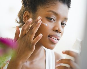 Woman applying sunscreen lotion