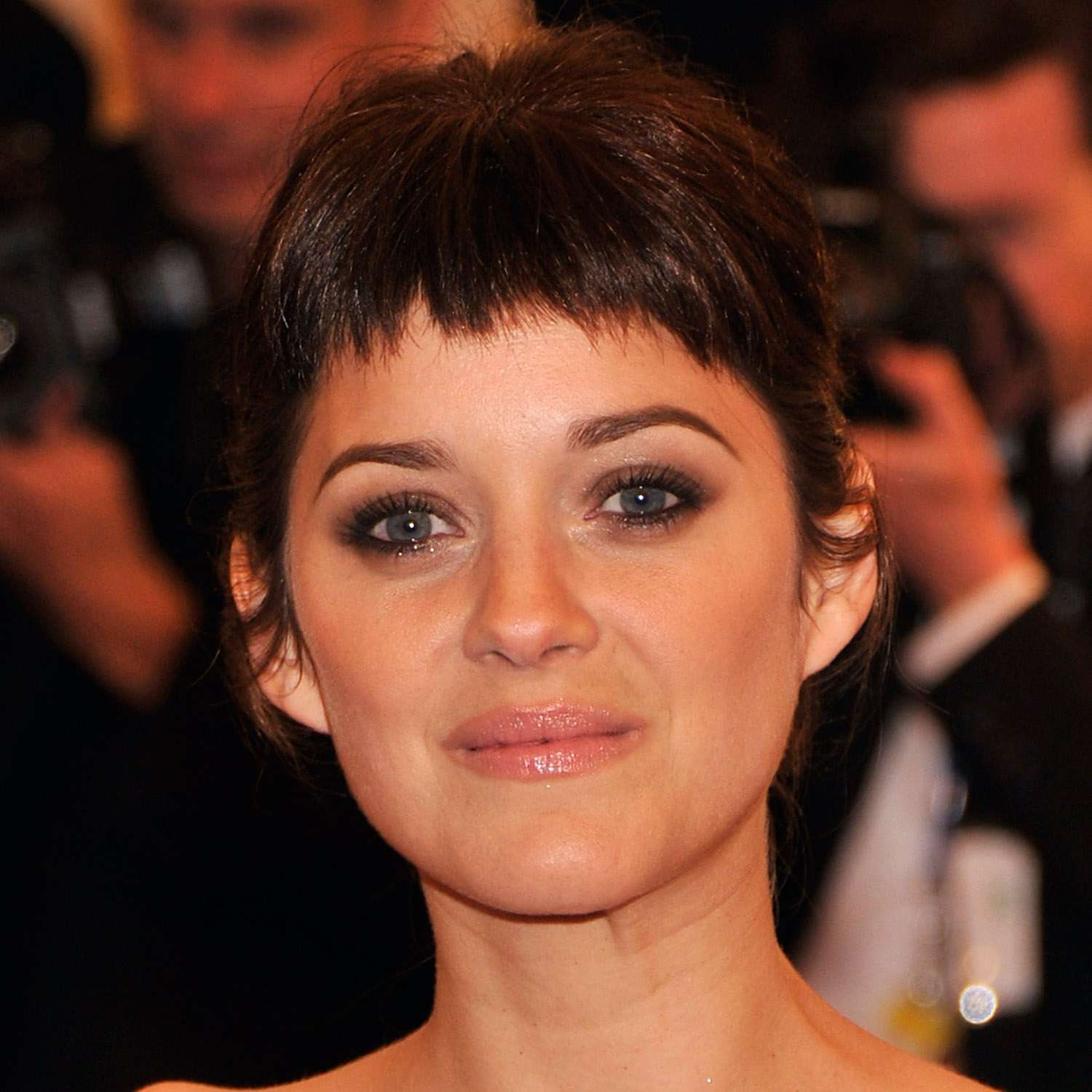 Marion Cotillard wears an updo with feathered baby bangs
