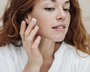 woman applying cold cream