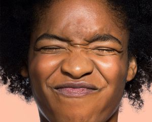 close-up of woman wrinkling nose