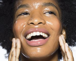 Black woman applying face cream