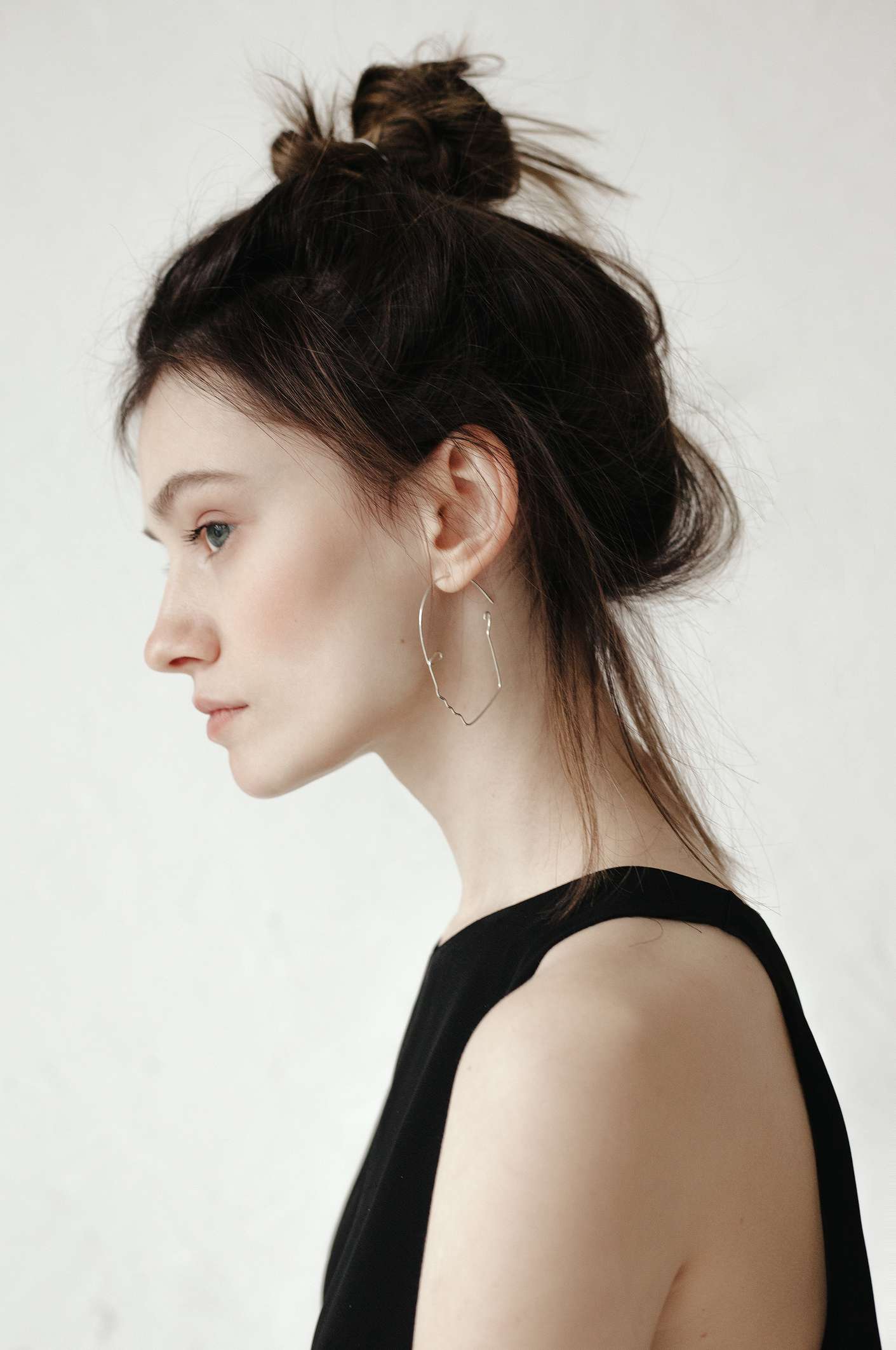 woman with updo and earring