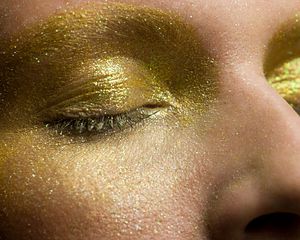 eyes covered in shimmering gold makeup