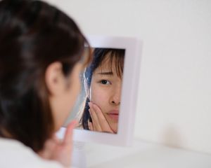 Woman taking care of rough skin