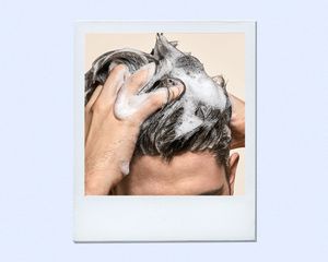 man using thickening shampoo on hair 
