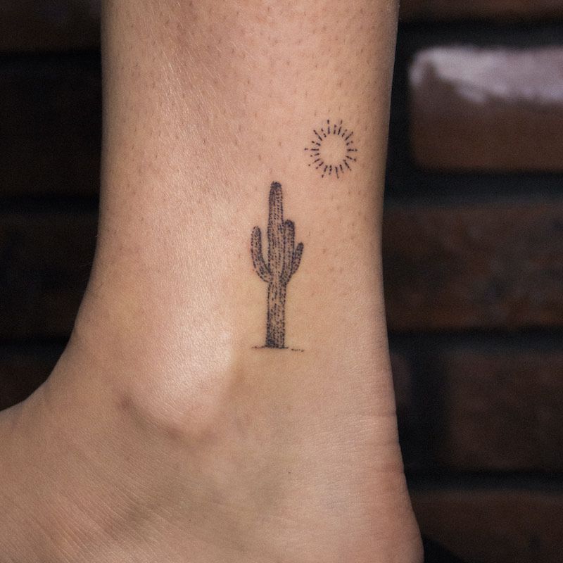 Cactus and sunshine stick-and-poke ankle tattoo