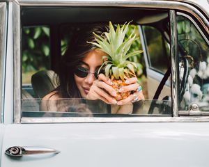 woman holding pineapple