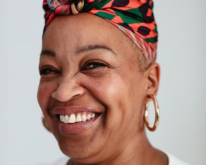 woman smiling with head wrap