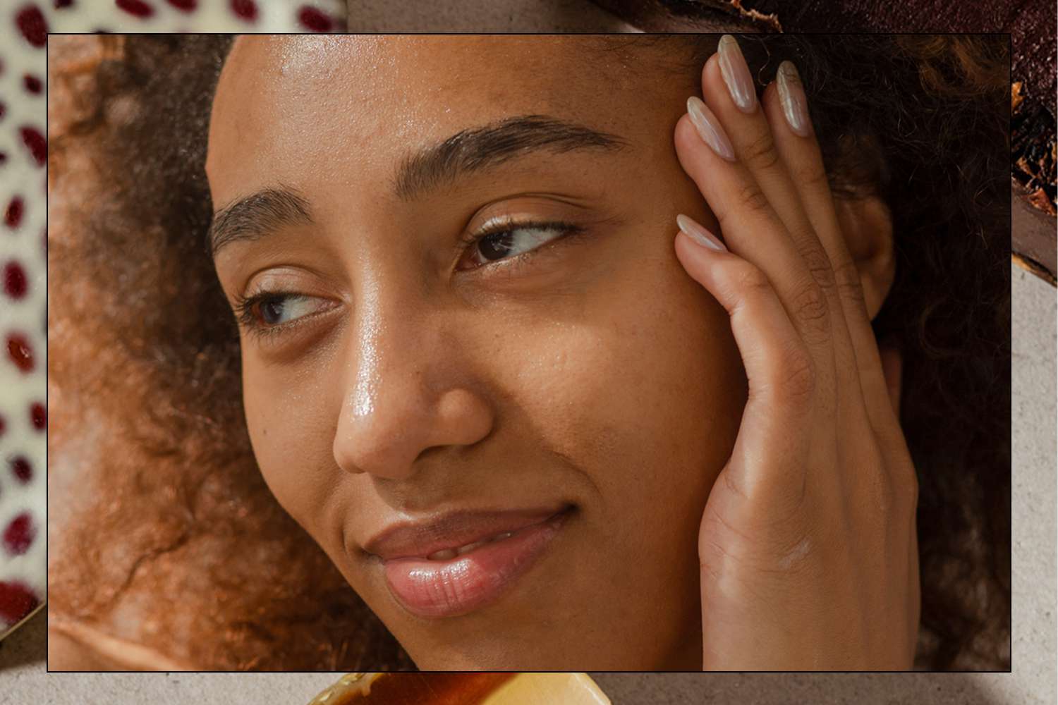 woman holding her hand to her face