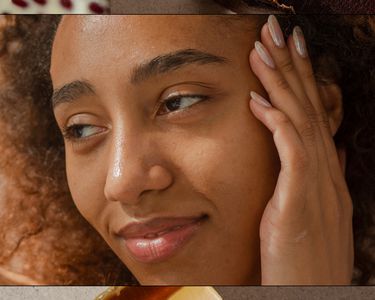 woman holding her hand to her face