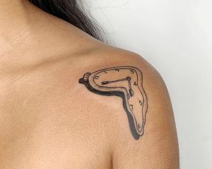 woman with salvador dali persistence of memory shoulder tattoo