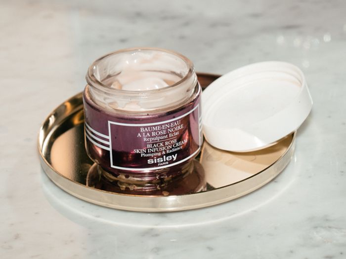 sisley paris black rose skin infusion cream on gold plate