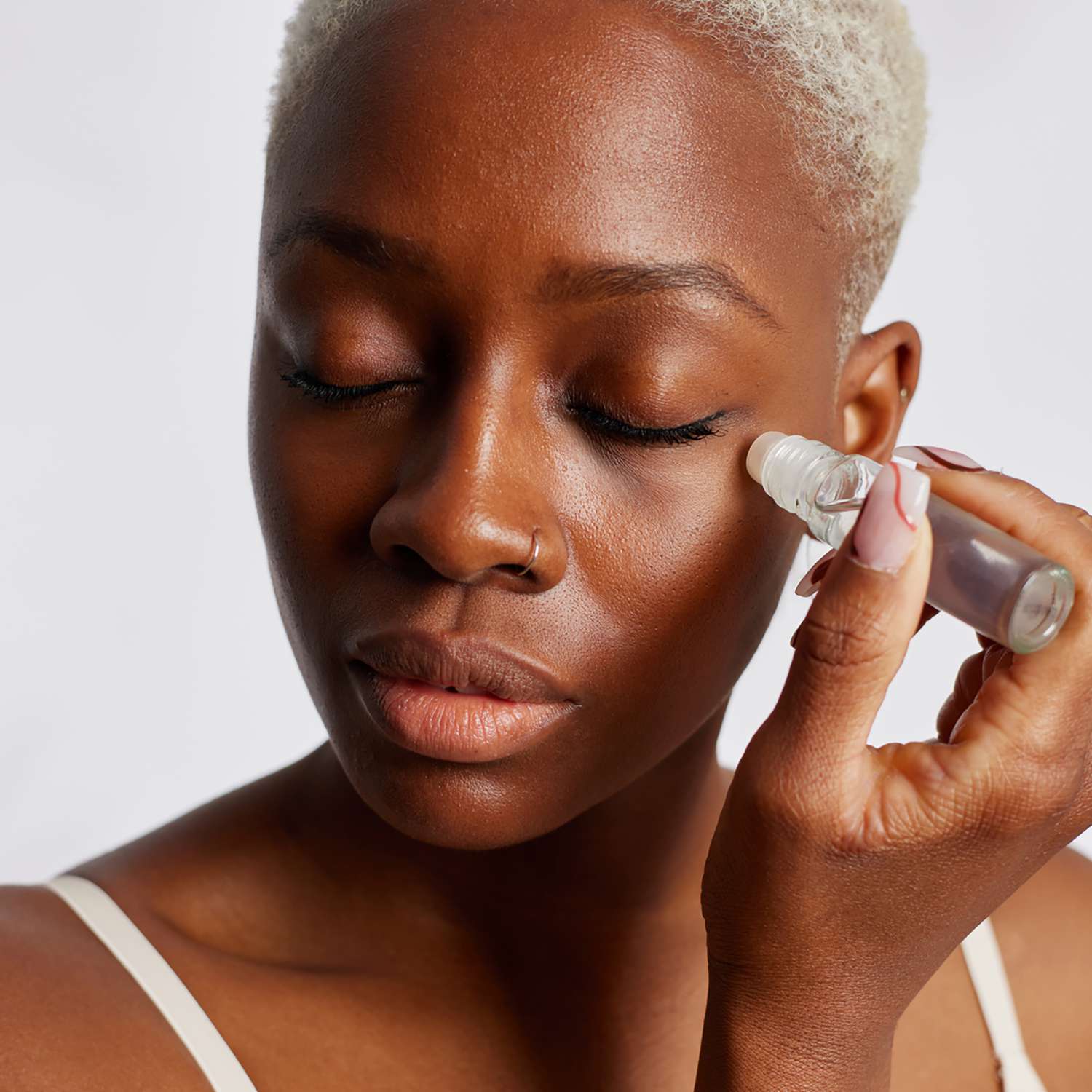 woman applying an eye gel under her eye