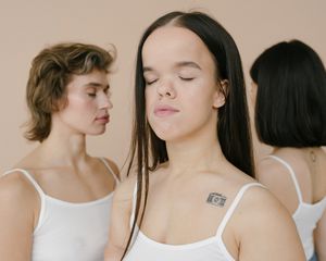 Three young women with their eyes closed