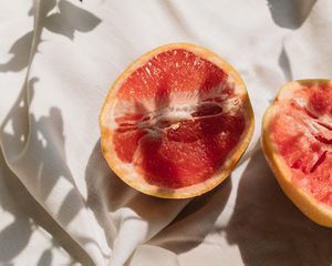 Close up of a grapefruit cut in half in sunlight.