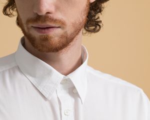 Up close of a masculine person with a red beard. 