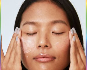 woman applying cream under eyes