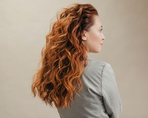 Behind view of a woman with voluminous red hair. 