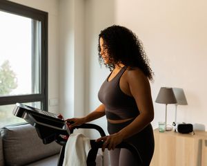 Woman on a treadmill at home.