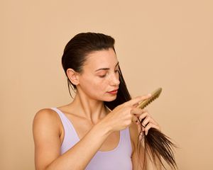 woman combing wet hair