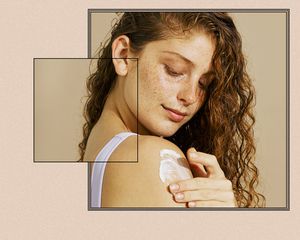 woman applying lotion to shoulder