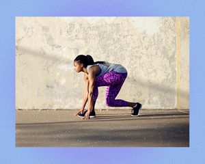 Woman crouching outside getting ready to work out