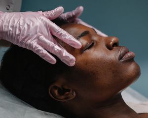 Woman receiving a facial massage from a professional.