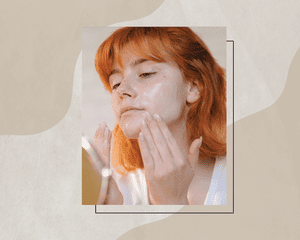 Woman with Redhair Applying Skin Products to Mask Some Skin Irritation