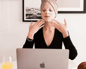 woman with face mask at computer