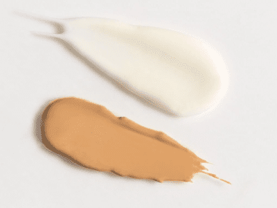 two swatches of sunscreen on white background